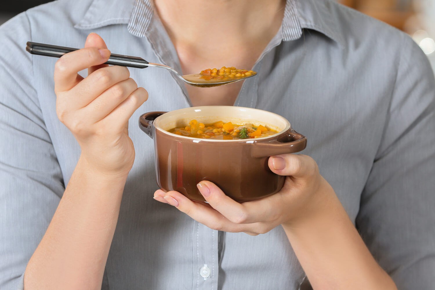 woman eating lentil soup