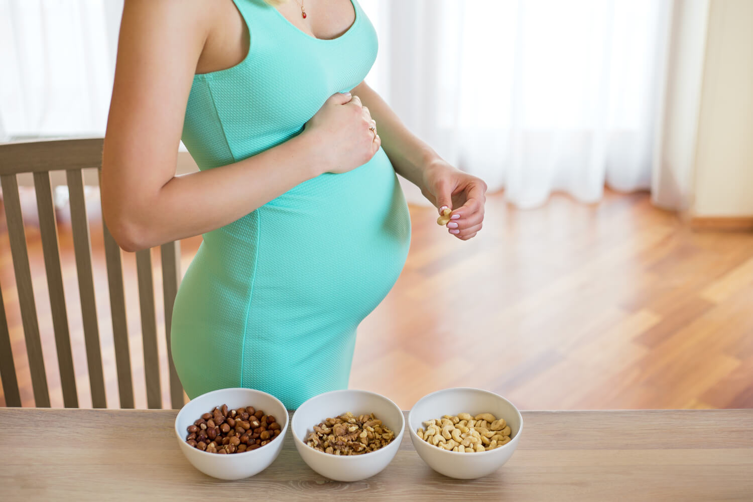 pregnant woman eating nuts