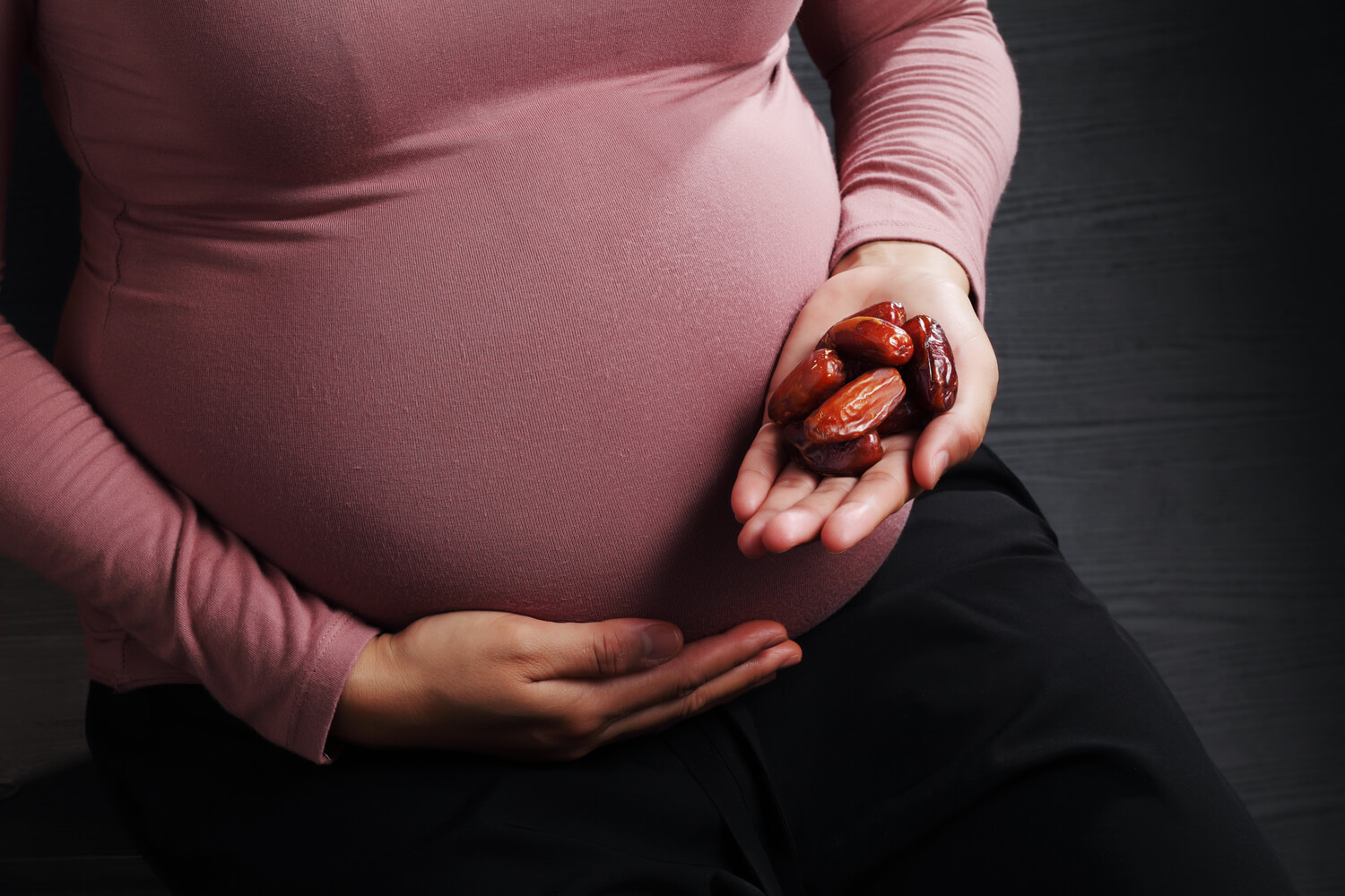 pregnant woman eating dried fruits