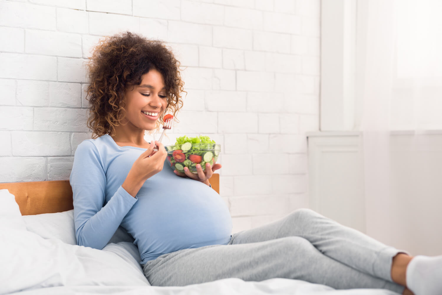 pregnant woman eating vegetable