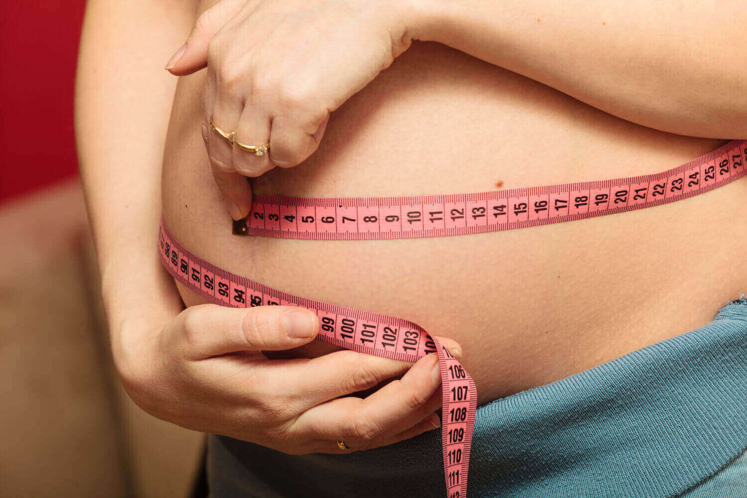 pregnant woman measuring tape