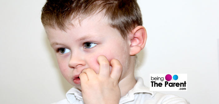 Boy biting his nails