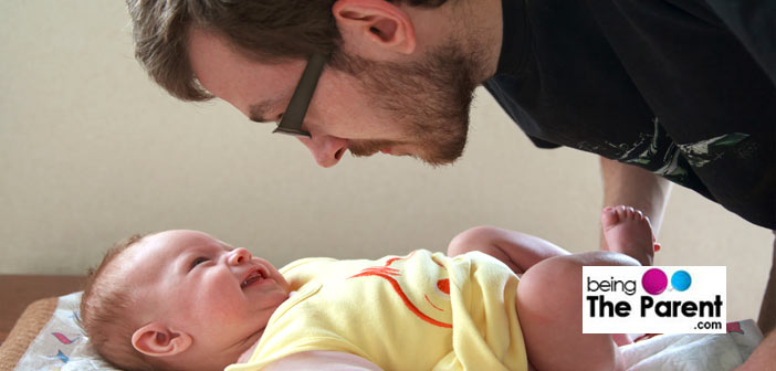 Dad changing baby