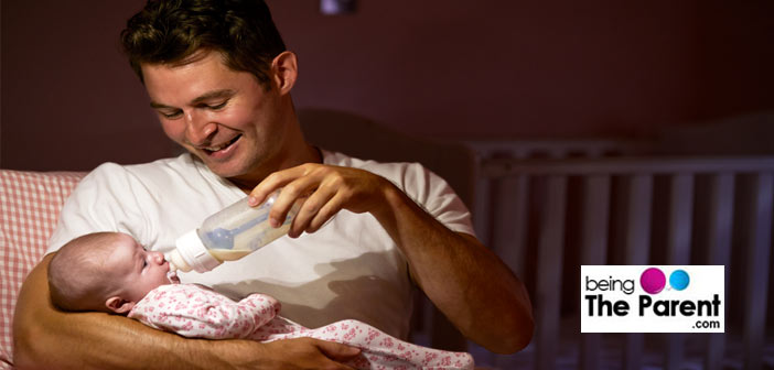 dad feeding baby