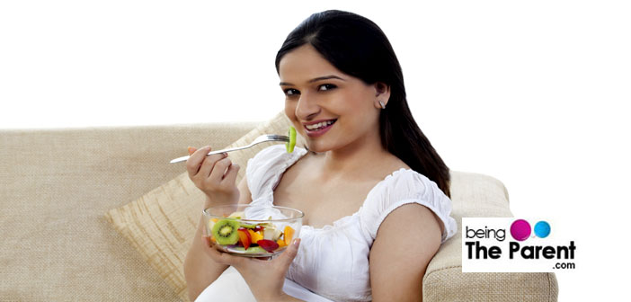 Pregnant woman eats fruits