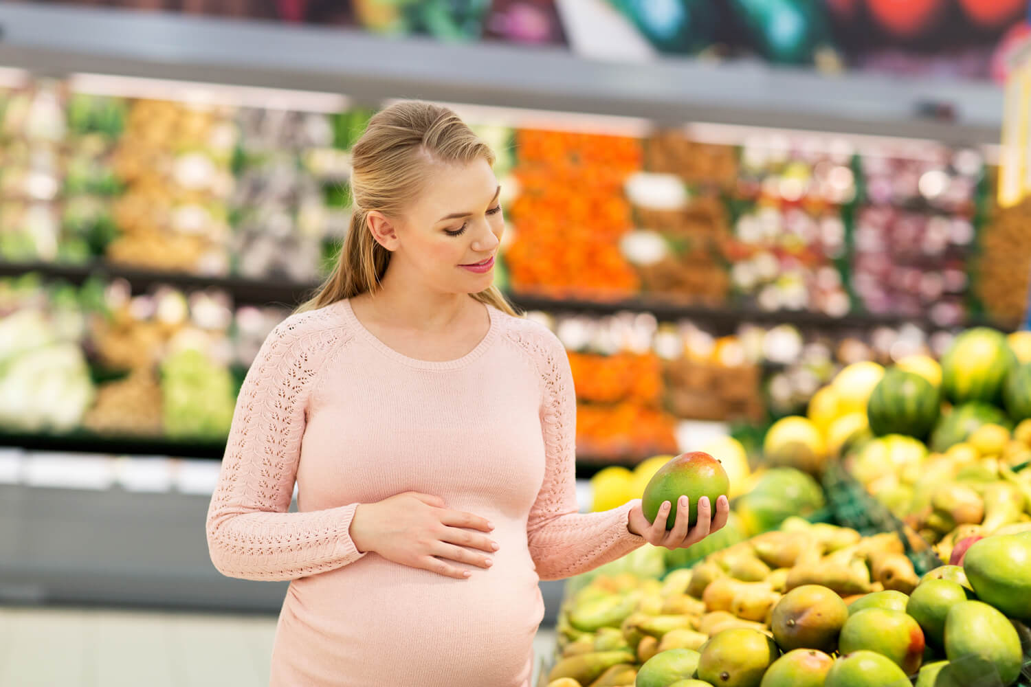 pregnant woman buying mango