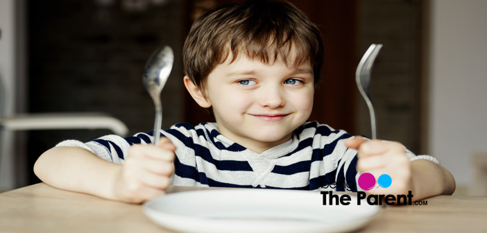 Child using fork and knife