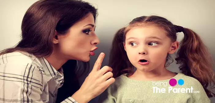 Mother telling secret to daughter