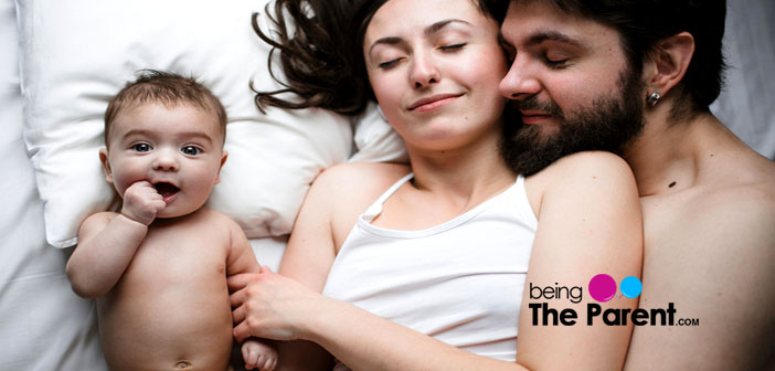 Couple in bed with baby