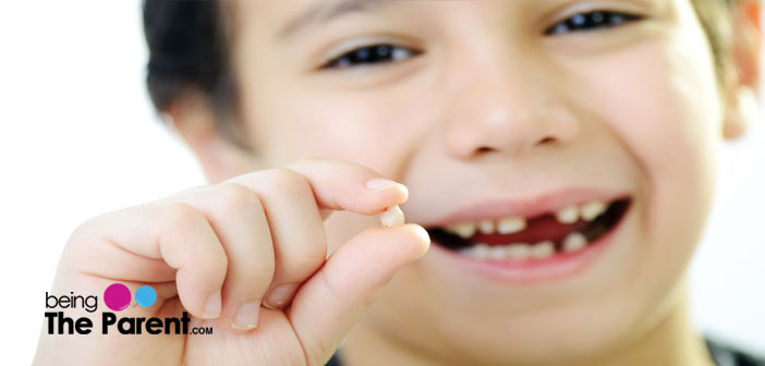 Boy shows off his fallen tooth