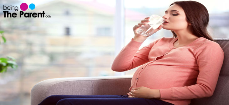 pregnant woman drikning water