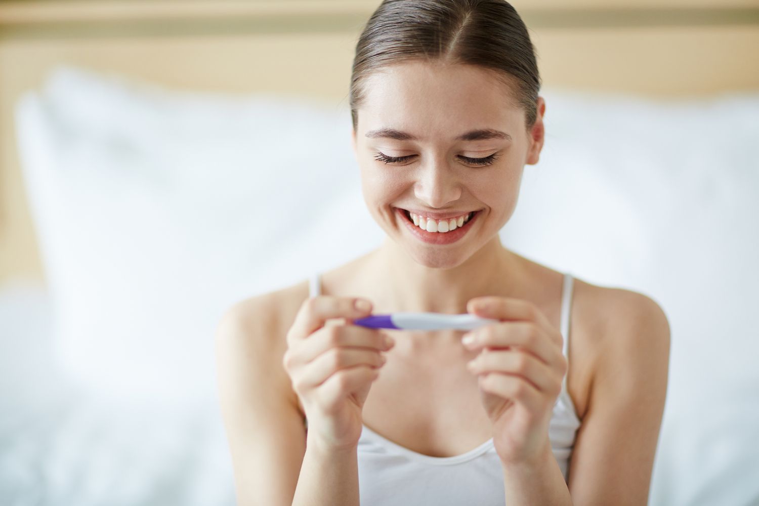 women testing pregnancy test result
