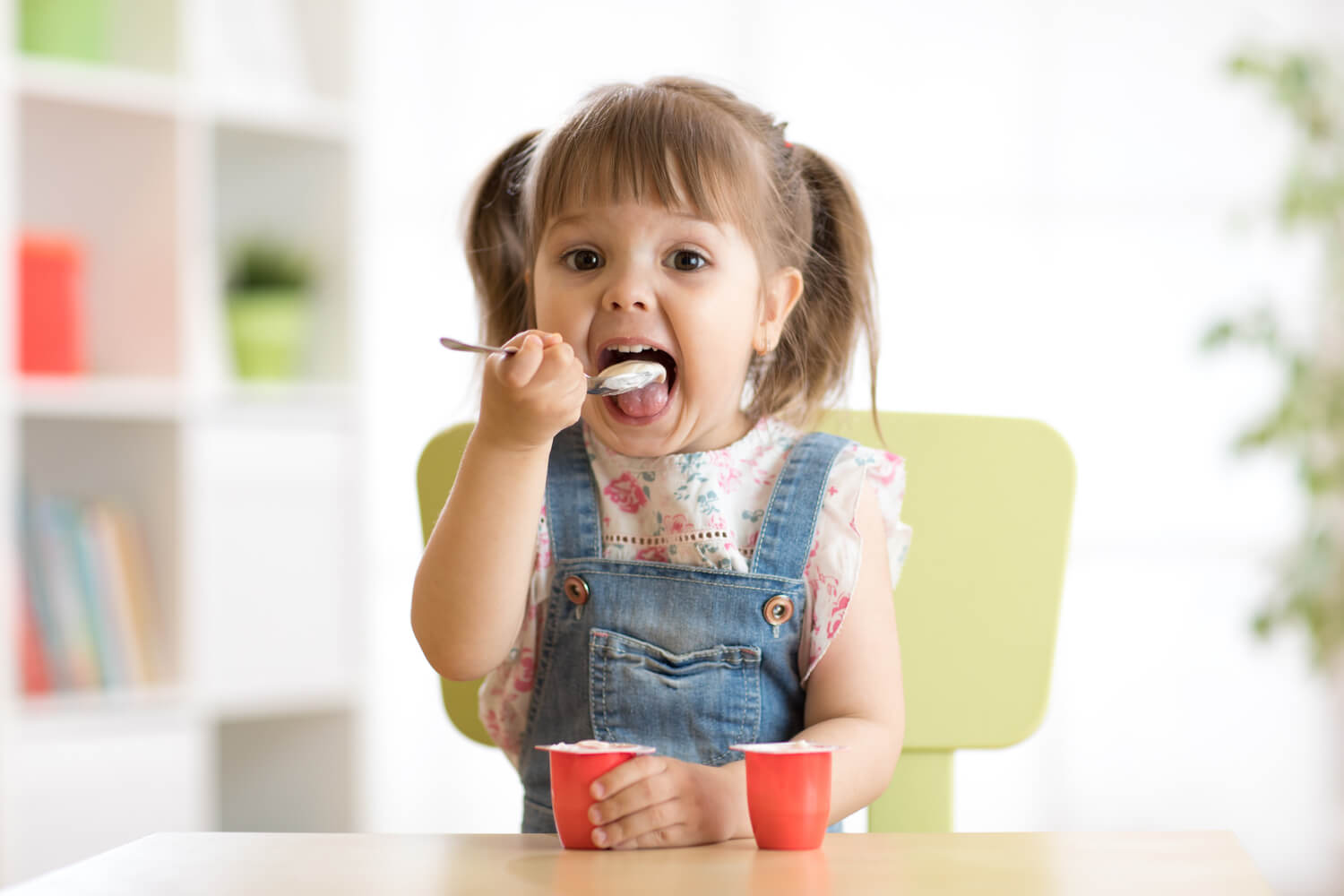 child eating yogurt