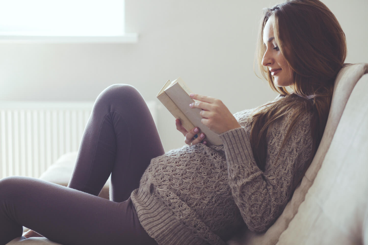pregnant women reading a book