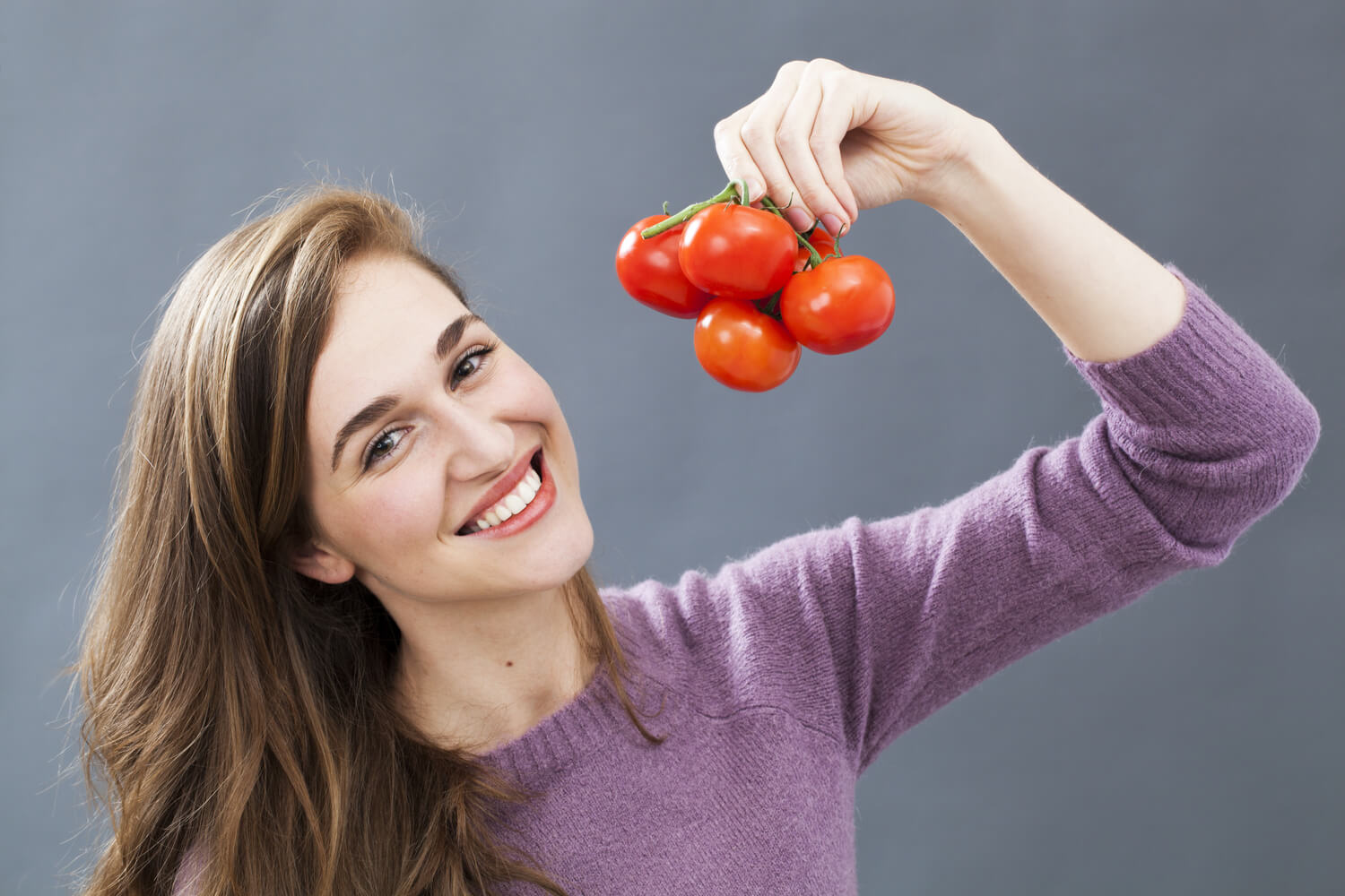 women showing bunch of tomatoes
