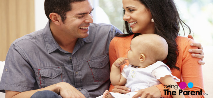 happy married couple with baby