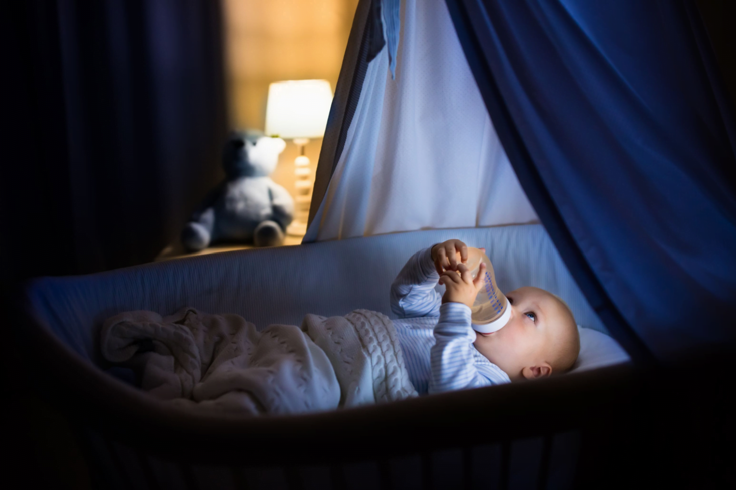 baby drinking in crib