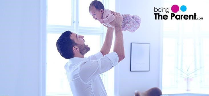 father holding newborn baby