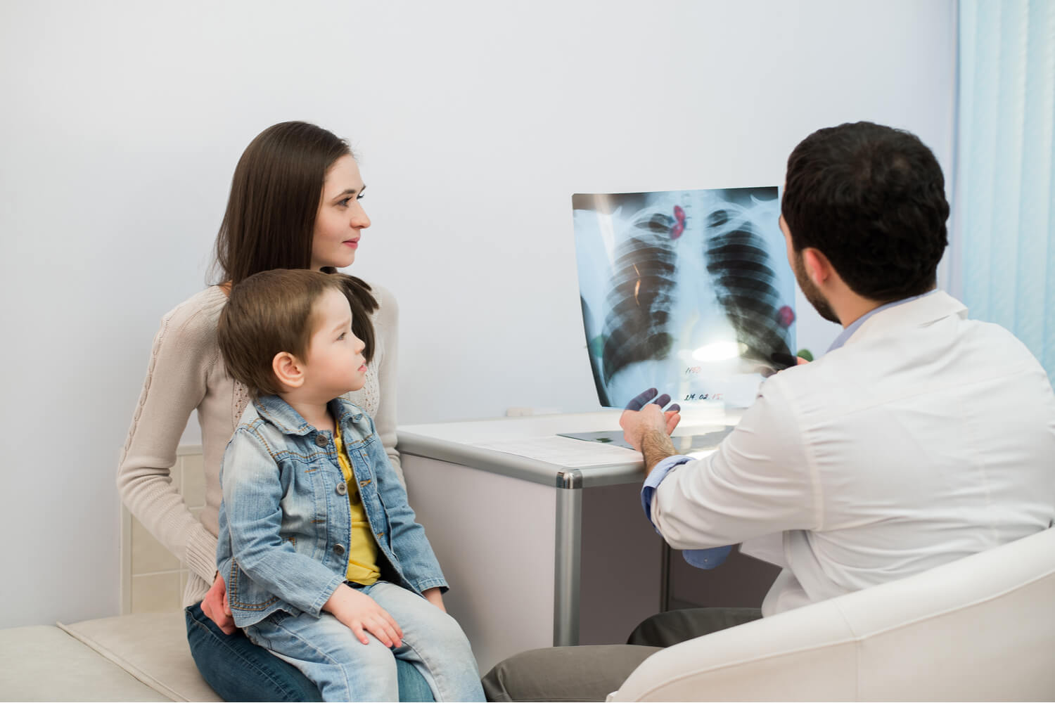 doctor checking x ray of kid