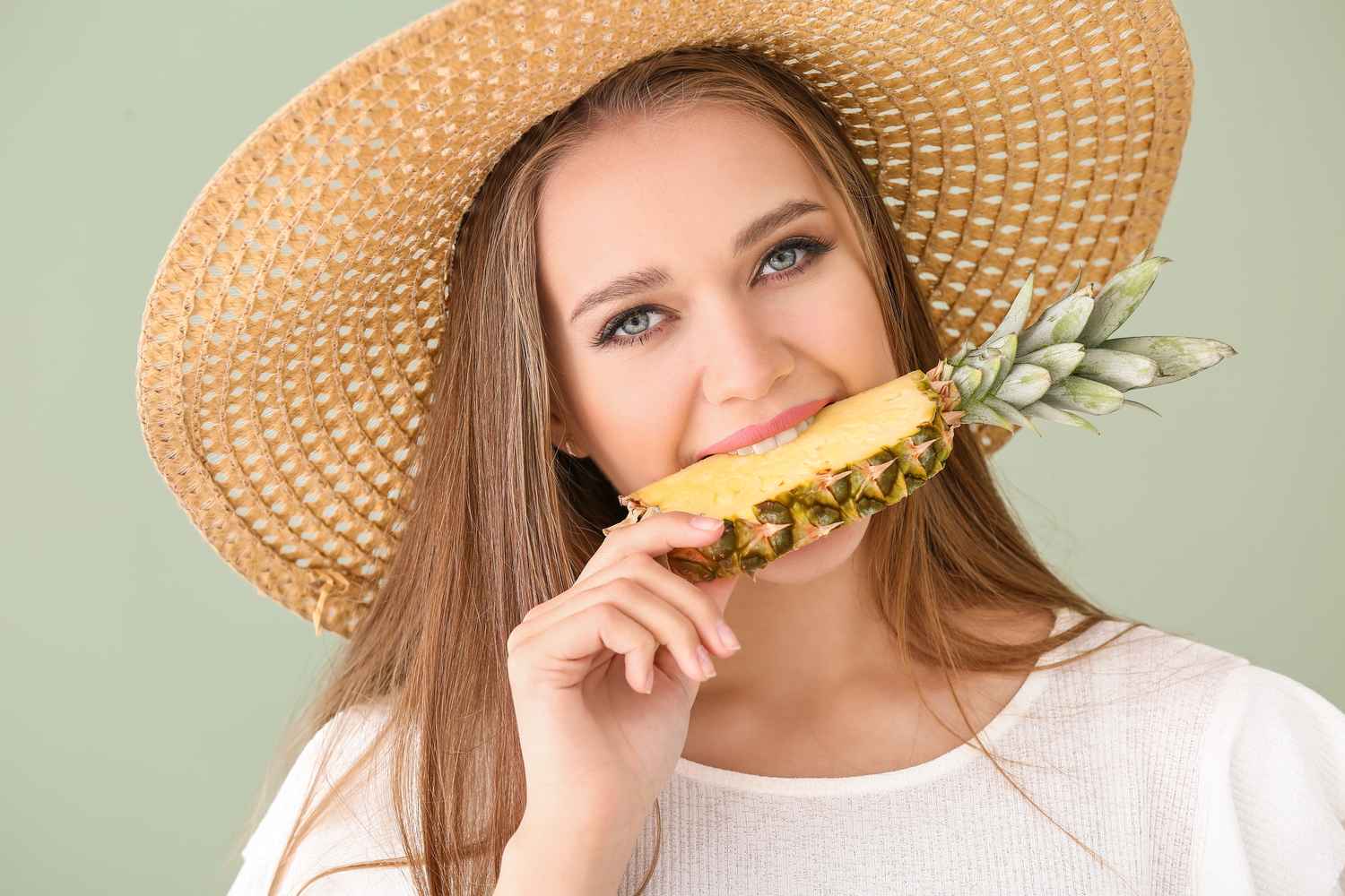 women eating pineapple