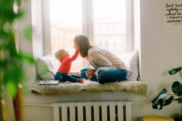 mother playing with baby