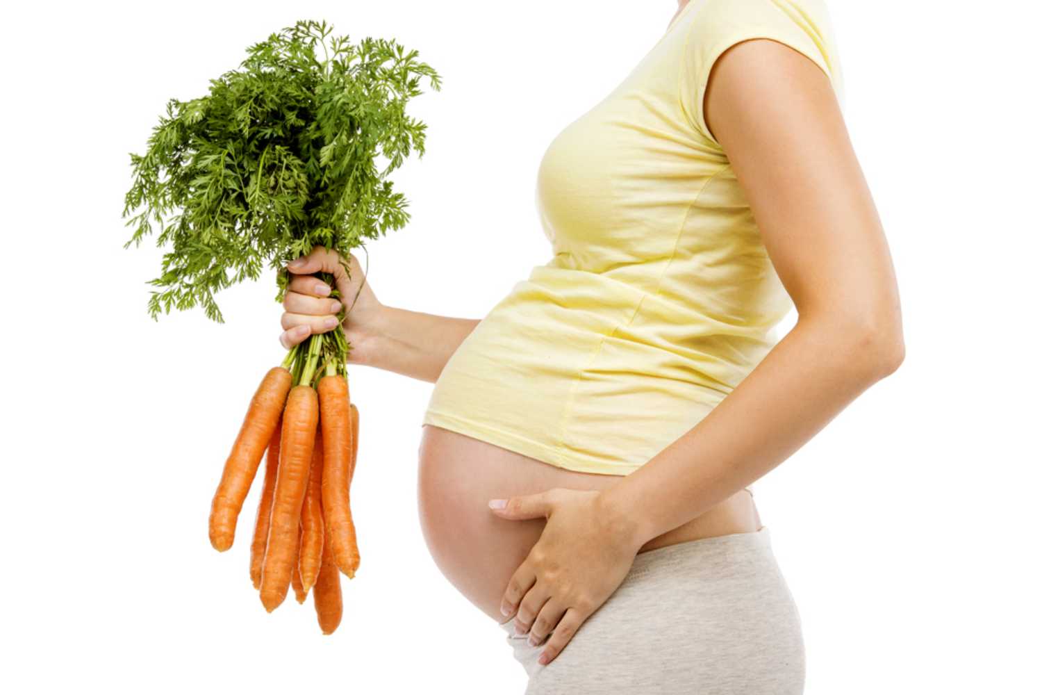 pregnant women holding carrot