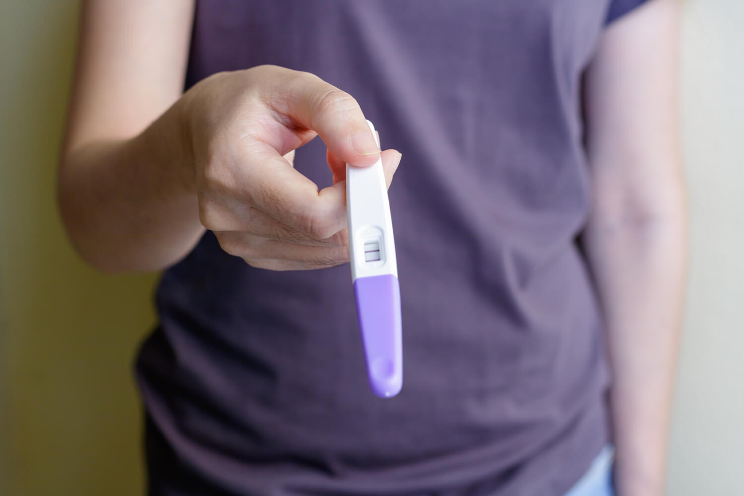 women holding pregnancy test