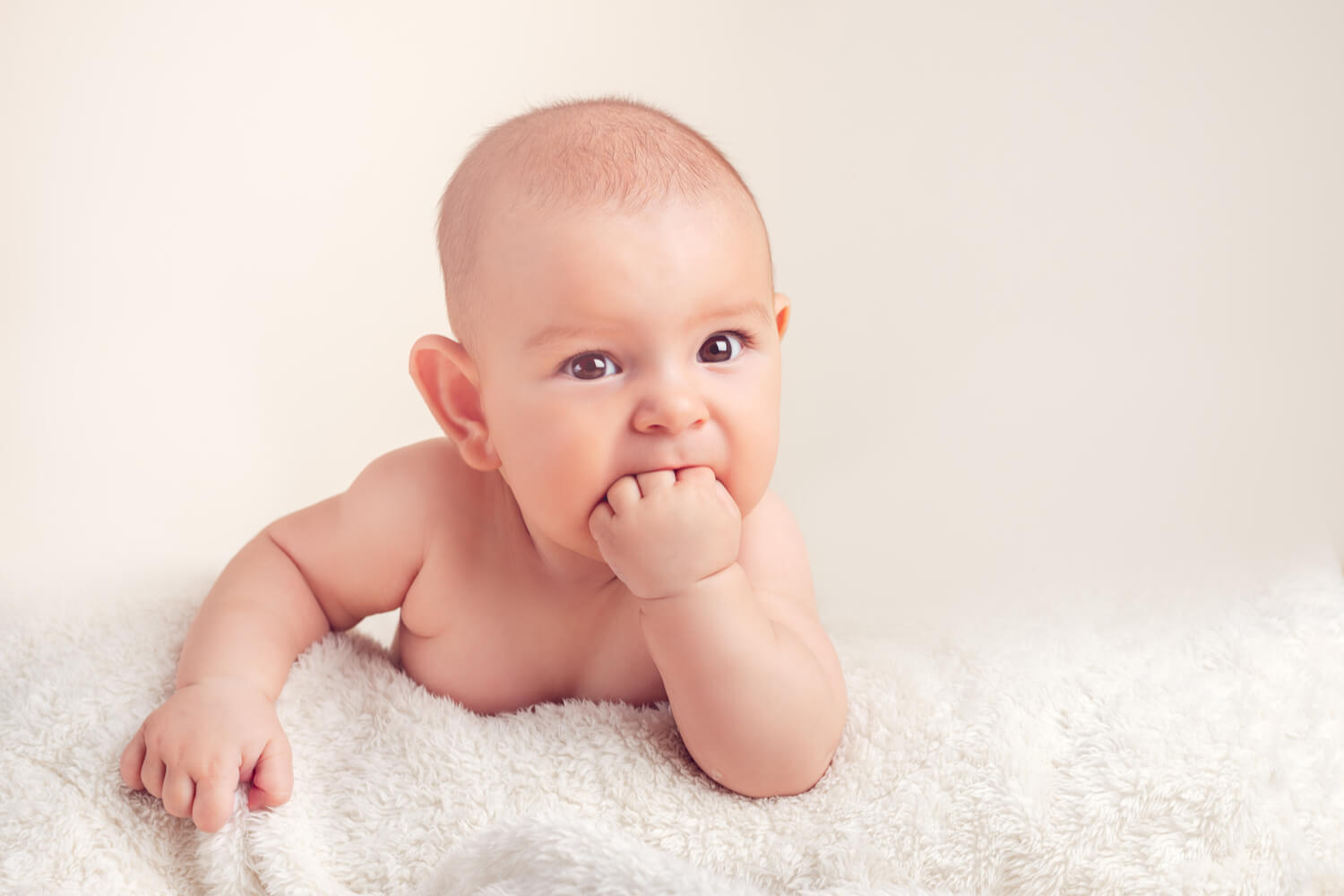 baby putting hand in mouth