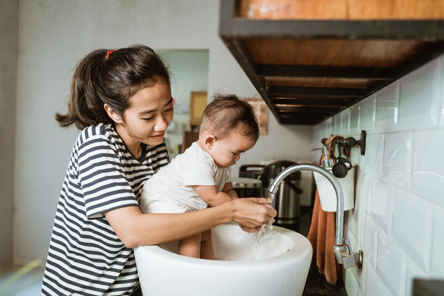 mom and baby washing hands