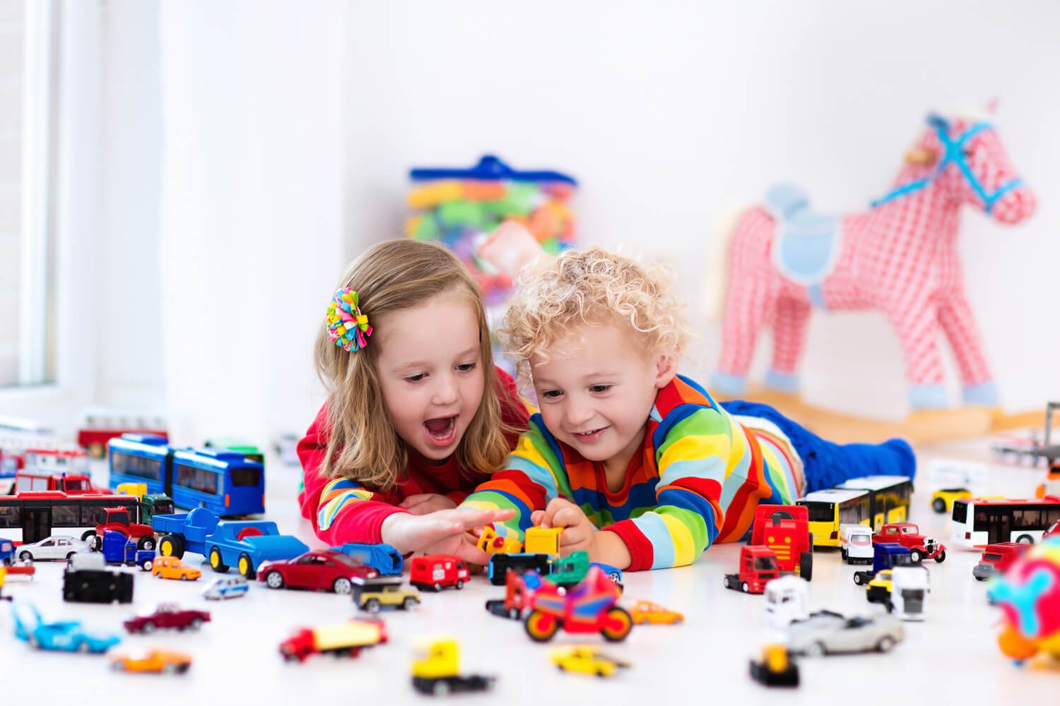 boy and girl playing with cars
