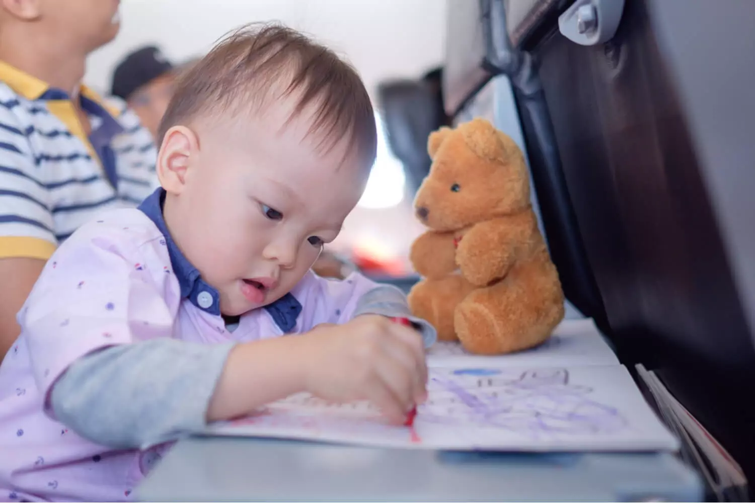 toddler colouring in a flight