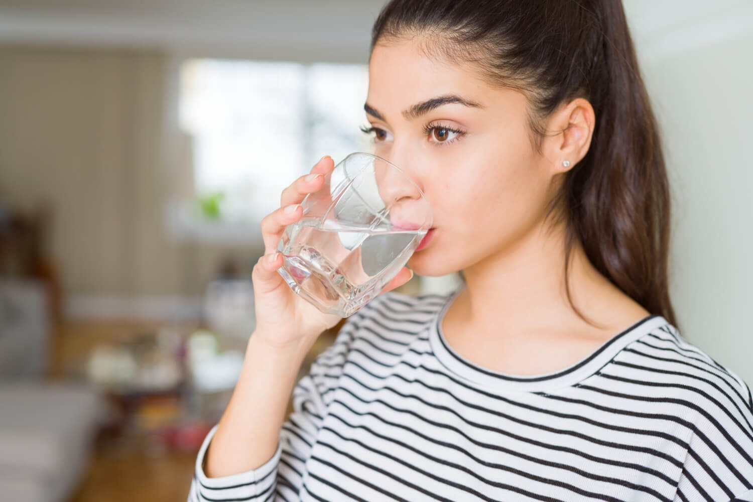 women drinking glass of water