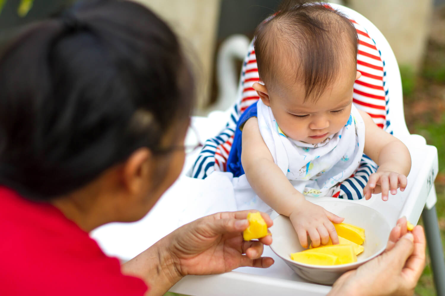 baby eating mango 