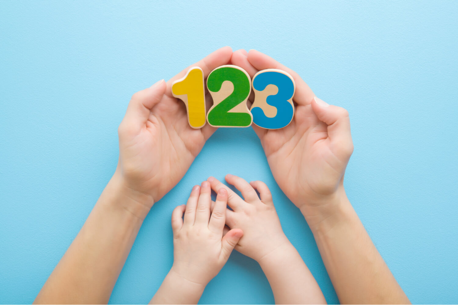hands of mother and child holding numbers