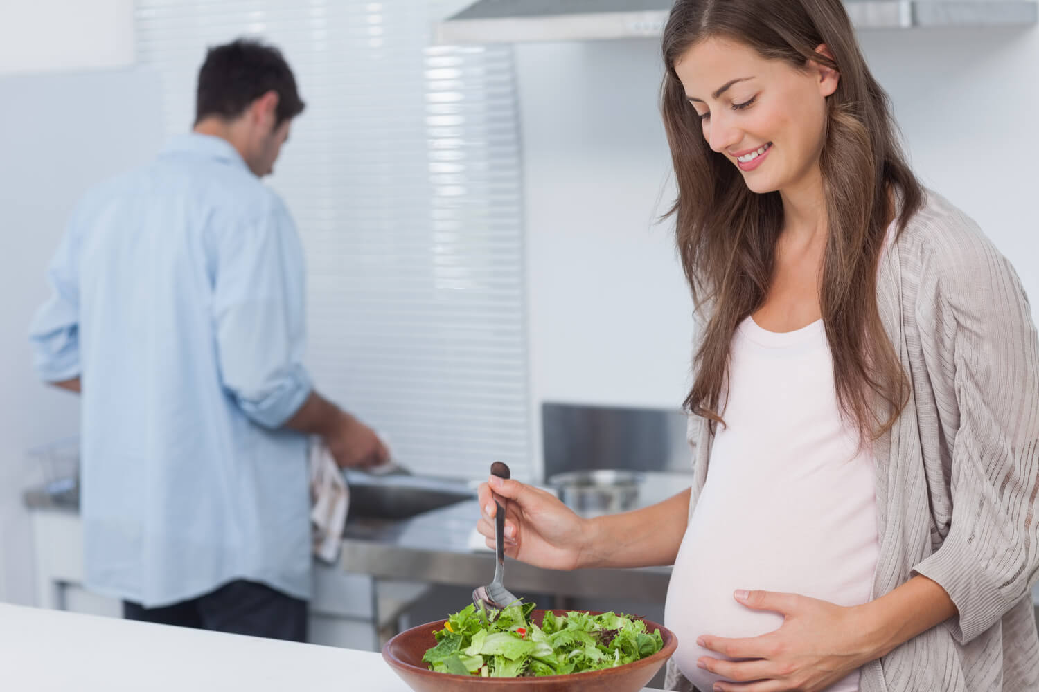 pregnant wife cooking with husband