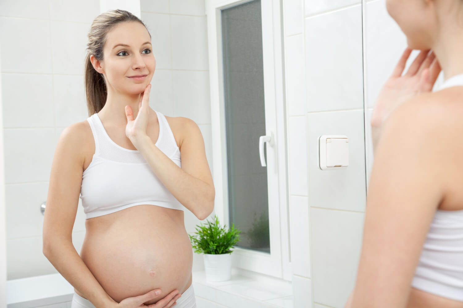 pregnant woman looking mirror