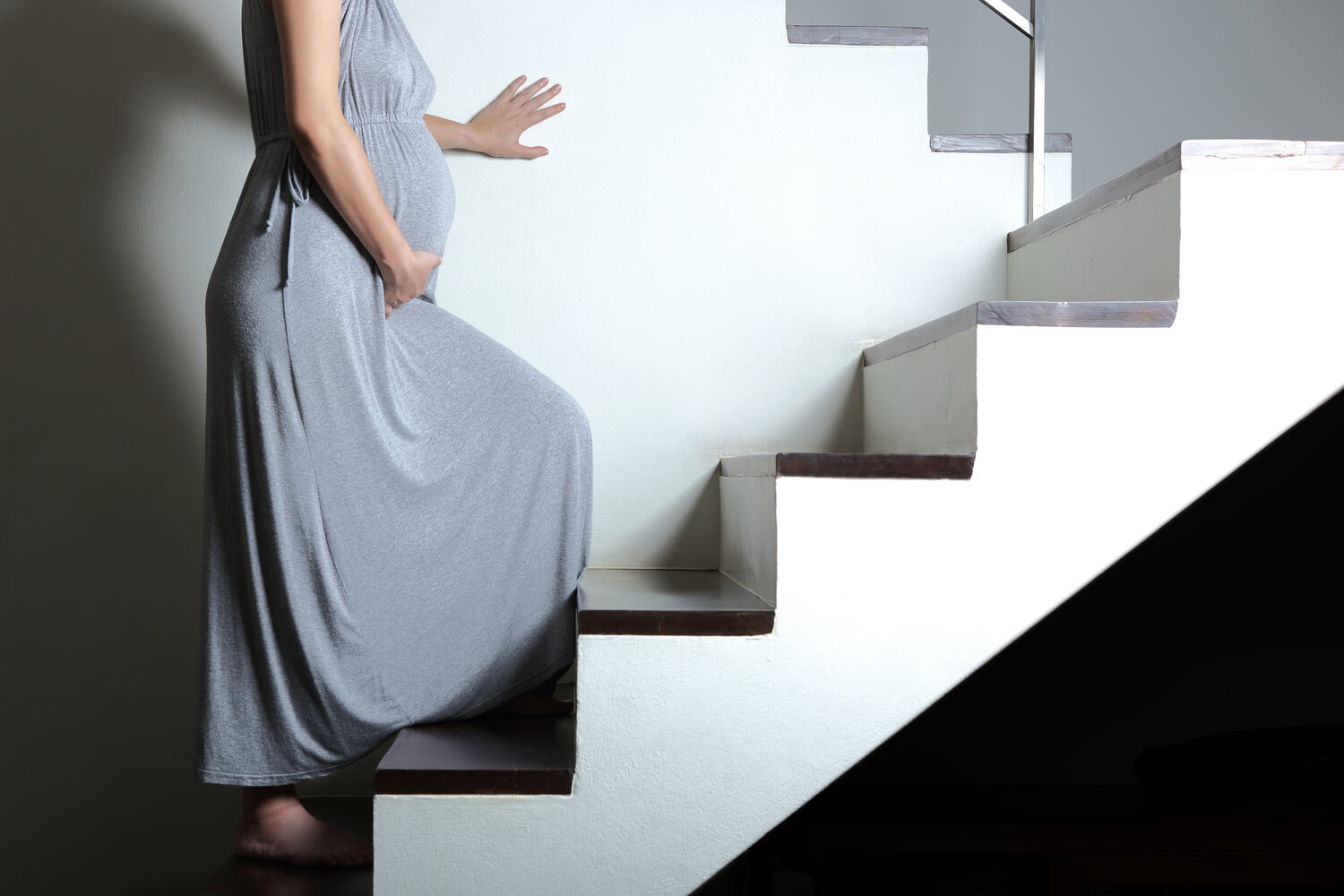 pregnant woman safely climbing stair