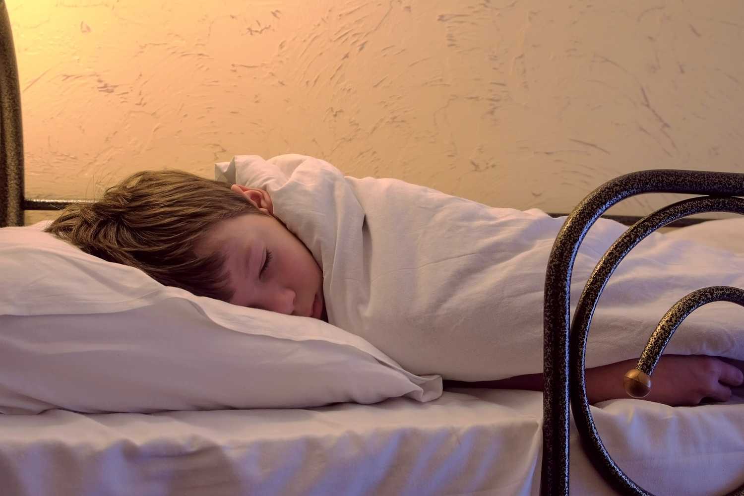 boy sleeping hostel bed
