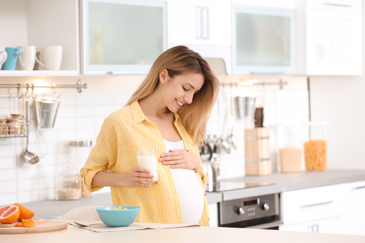 pregnant women with glass of milk