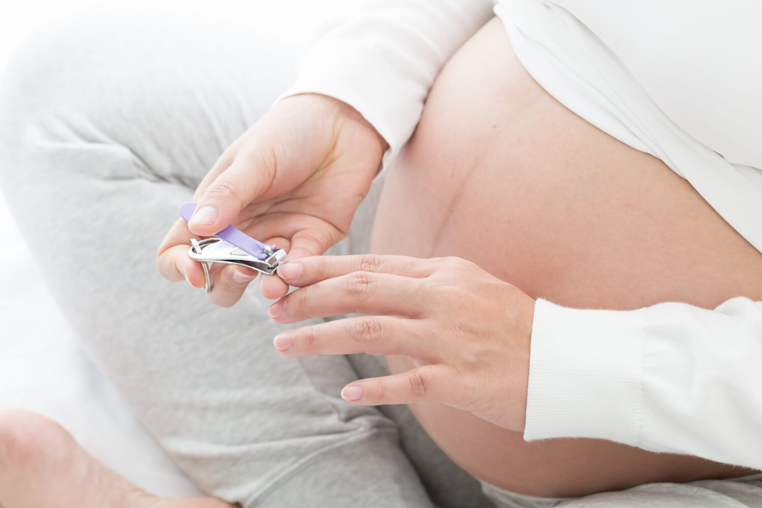 pregnant women cutting nail