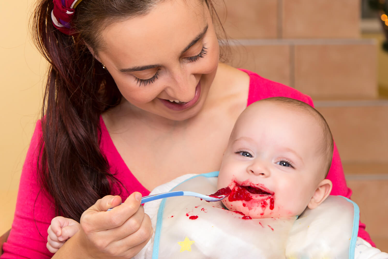 mom and baby eating beetroot puree