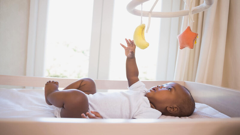 baby-reaching-a-toy