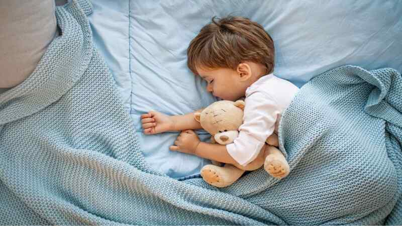 baby sleeping with a snuggly toy