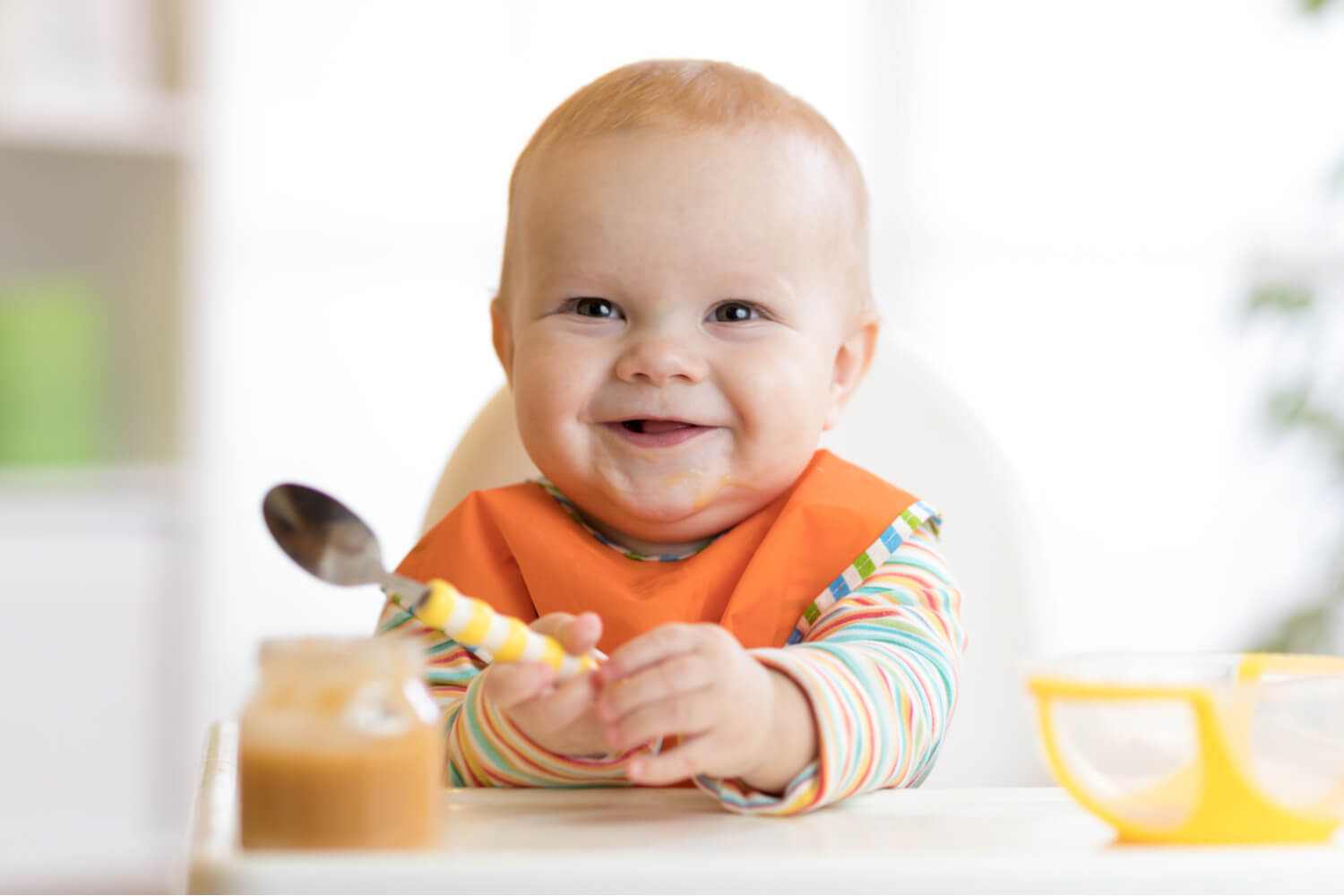 happy baby with spoon