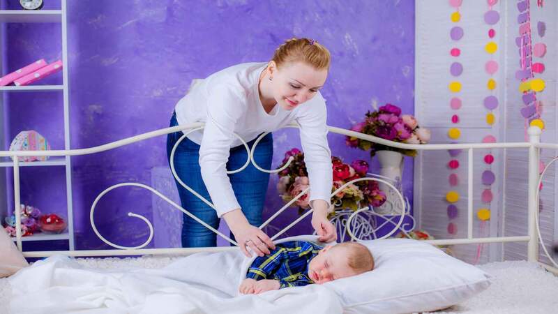 mom checking a sleeping baby