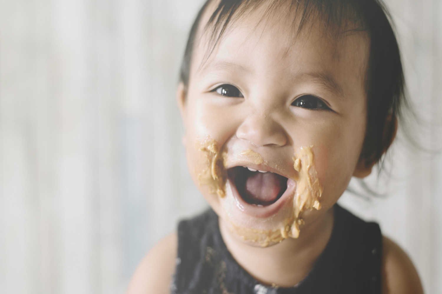 baby eating peanut butter