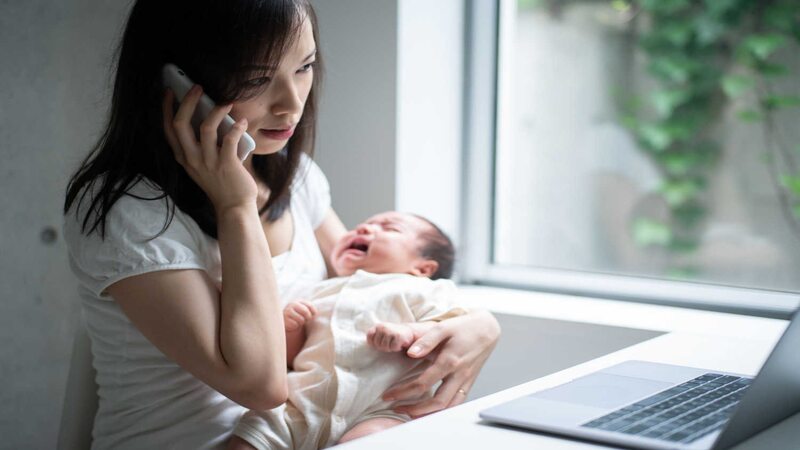 mother with newborn calling doctor