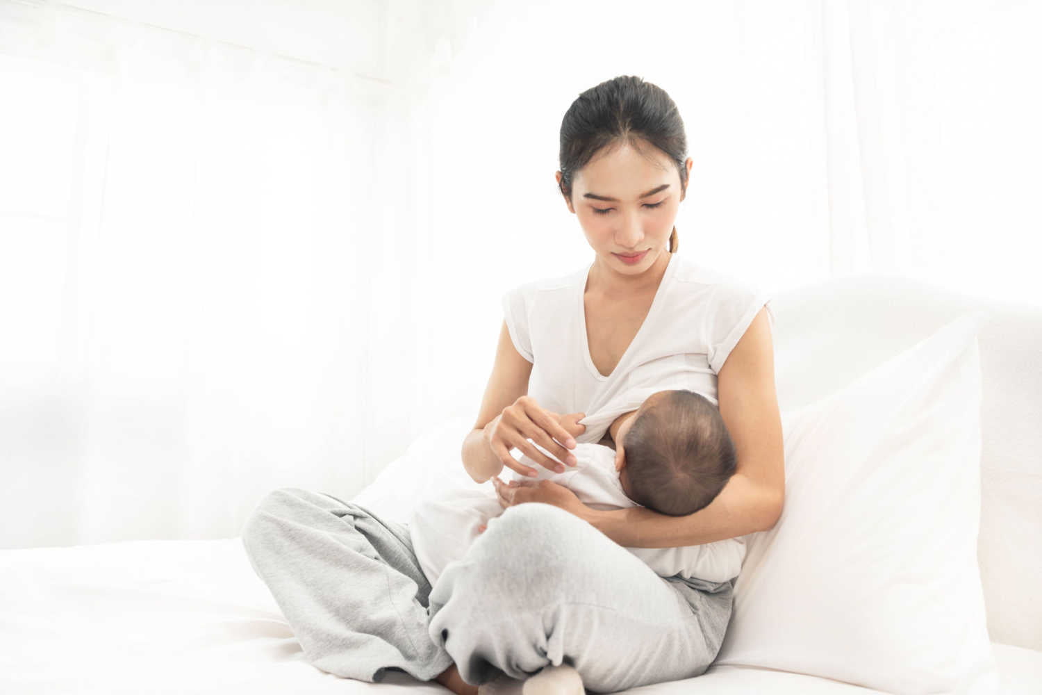 mom breastfeeding a sick baby