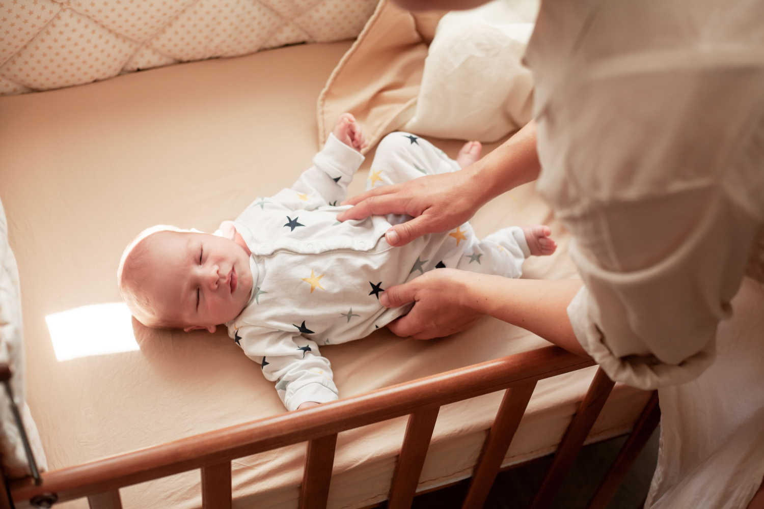 mom trying to wake a sleeping baby