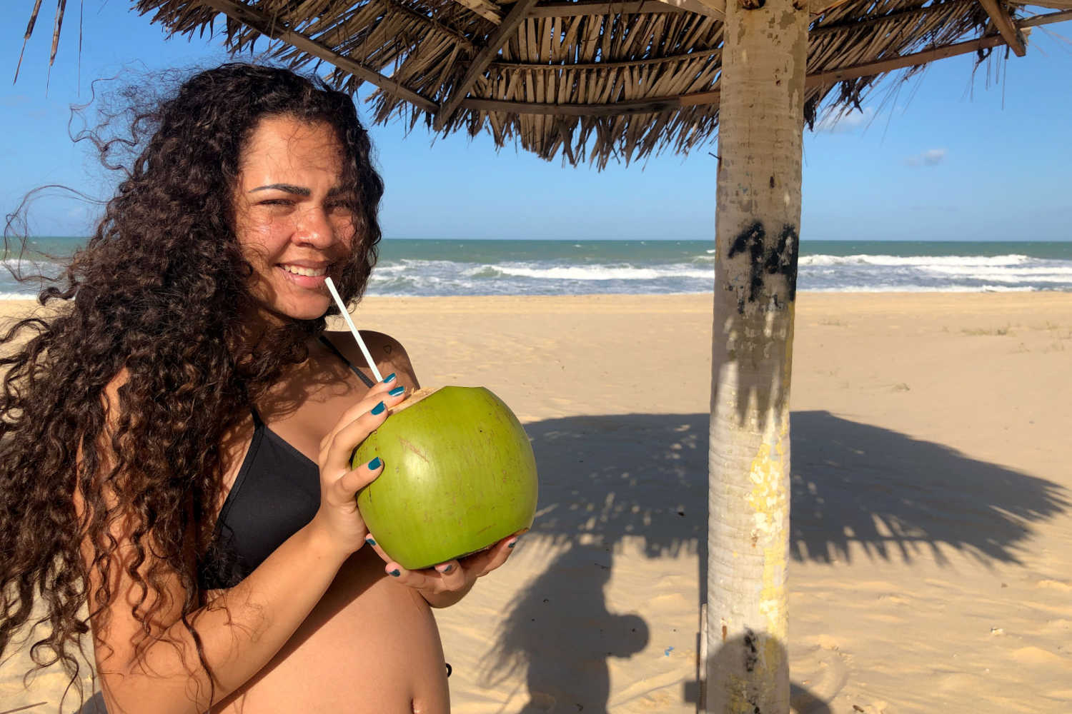 women drinking coconut water
